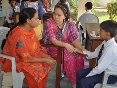 A Volunteer Doctor From the Philippines Examines a Student in Farooqabad Day School